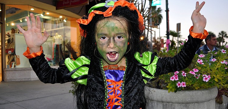 Giordana Spagnolo, 6, does her scariest witch impression Wednesday, Oct. 31, on St. Armands Circle. Spagnolo lost her first tooth that day which added to her scary witch persona.