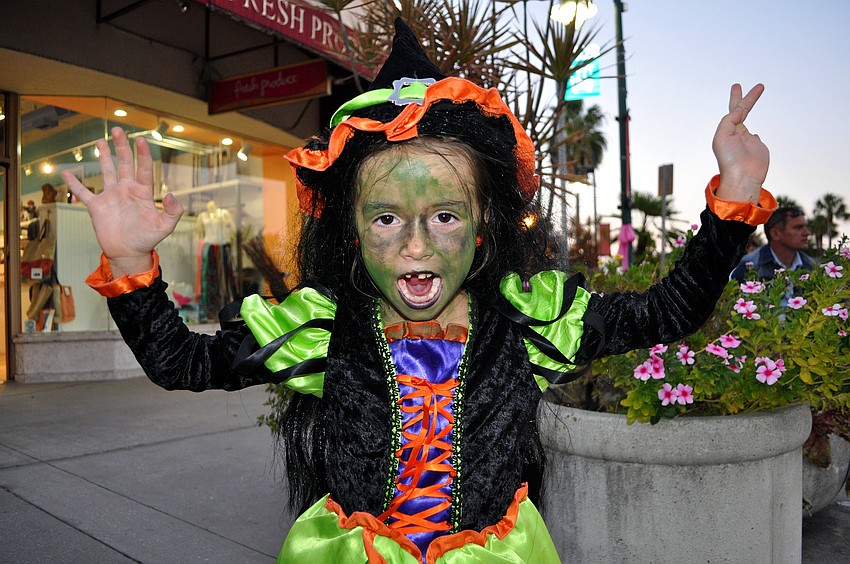 Giordana Spagnolo, 6, does her scariest witch impression Wednesday, Oct. 31, on St. Armands Circle. Spagnolo lost her first tooth that day which added to her scary witch persona.