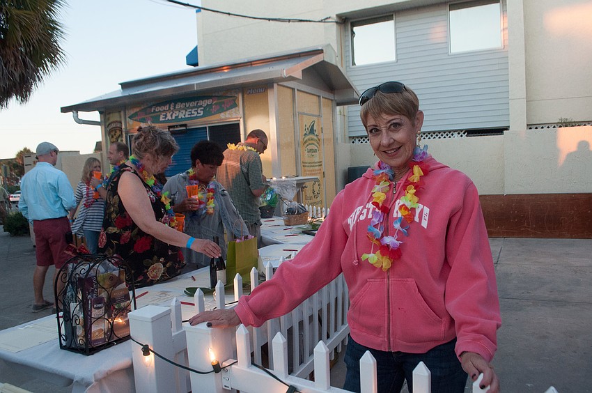 Joan Woods volunteers at the silent auction table.