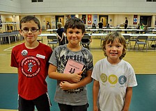Niocholas Clifton, Ari Ginsberg-Klemmt and Jaden Probus pose after finishing their games.