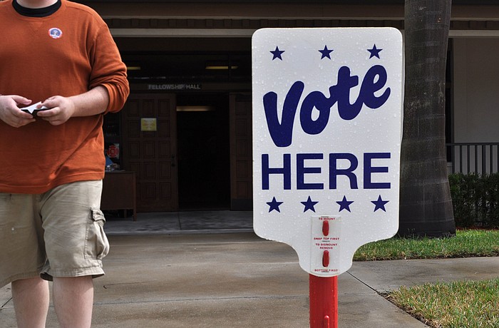 A man walks past wearing his "I Voted" sticker after casting his ballot at First Presbyterian, one of the many polling places in town Wednesday, Nov. 6, Election Day.