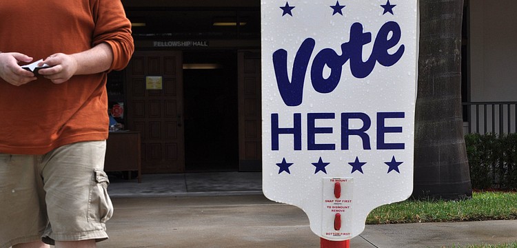 A man walks past wearing his "I Voted" sticker after casting his ballot at First Presbyterian, one of the many polling places in town Wednesday, Nov. 6, Election Day.