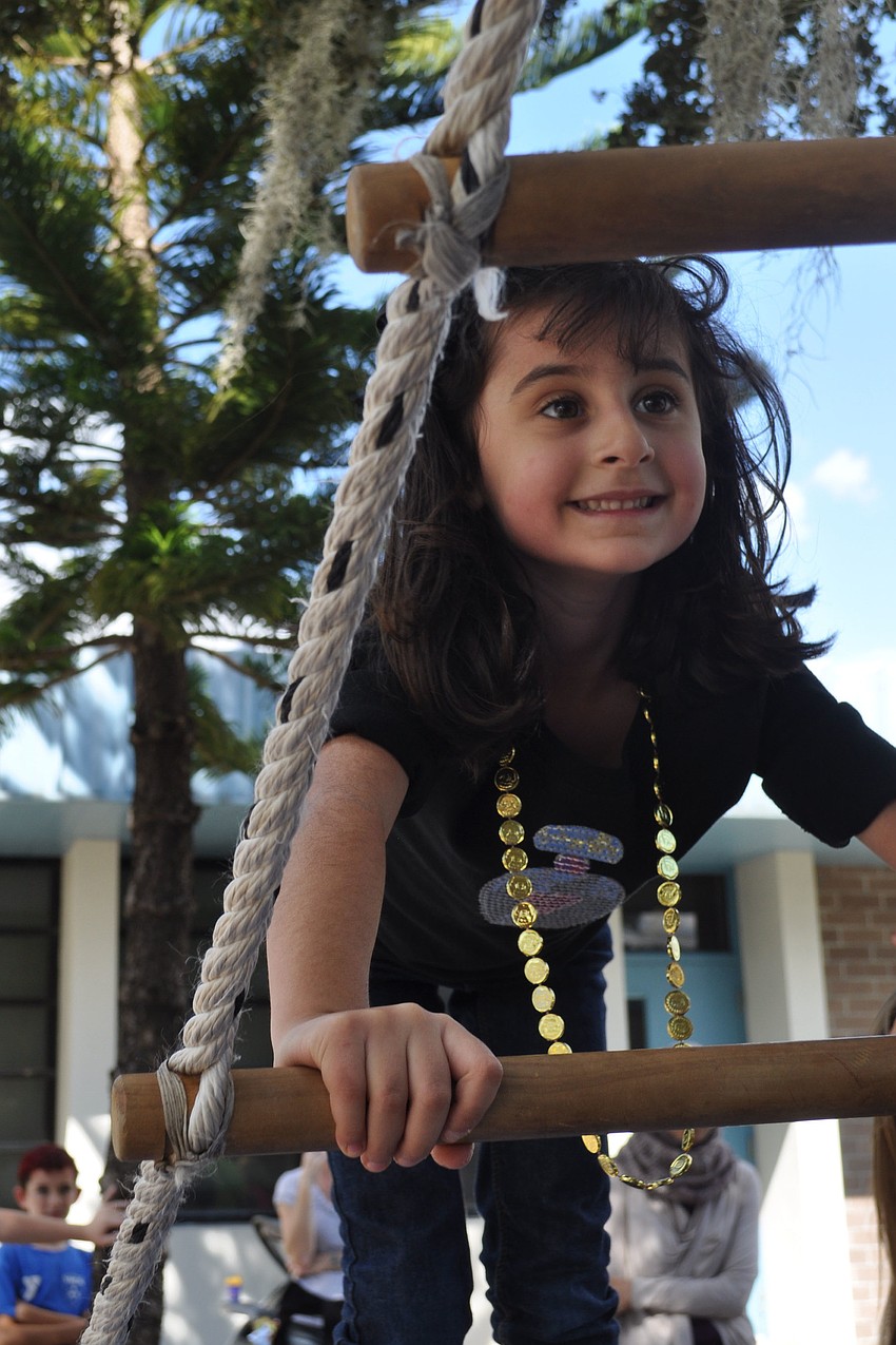 Breana Nasser climbed the tight rope to reach a cowbell.