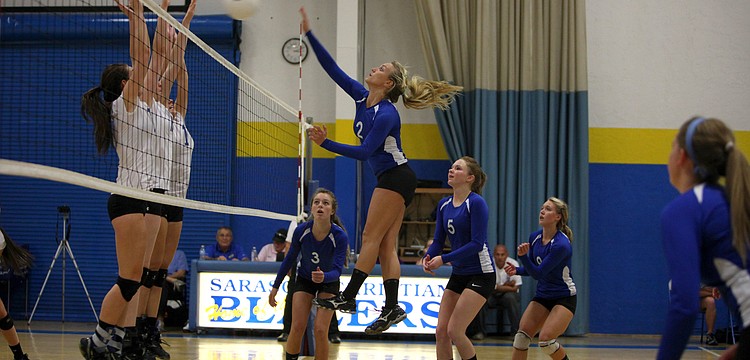 Janie Weaver, No. 2, spikes the ball over the net at Lake Worth Christian.