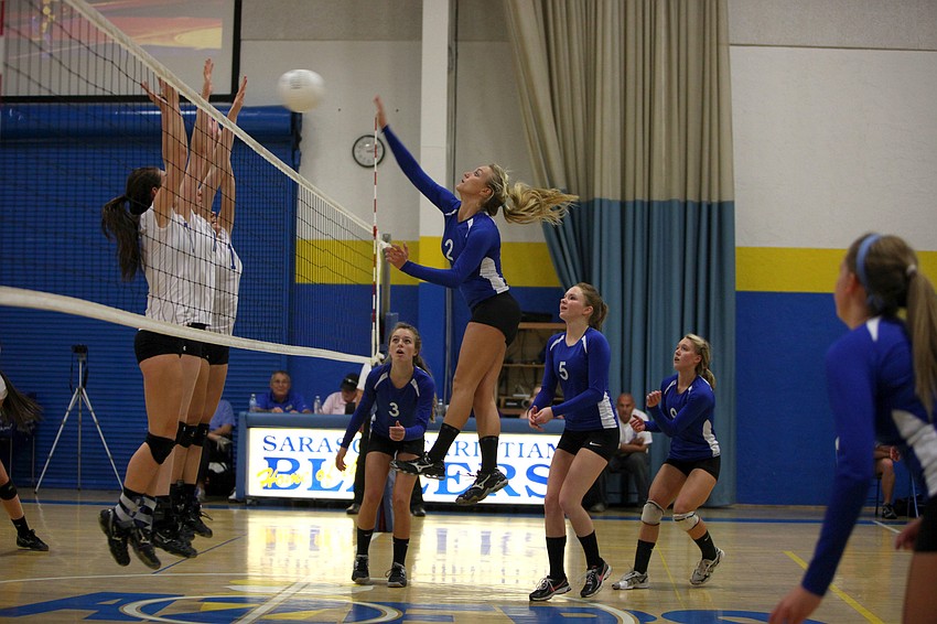 Janie Weaver, No. 2, spikes the ball over the net at Lake Worth Christian.