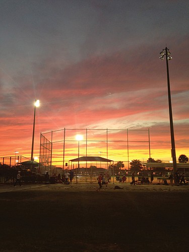 Maria Mercadante took this photo of the sun setting over a softball field.