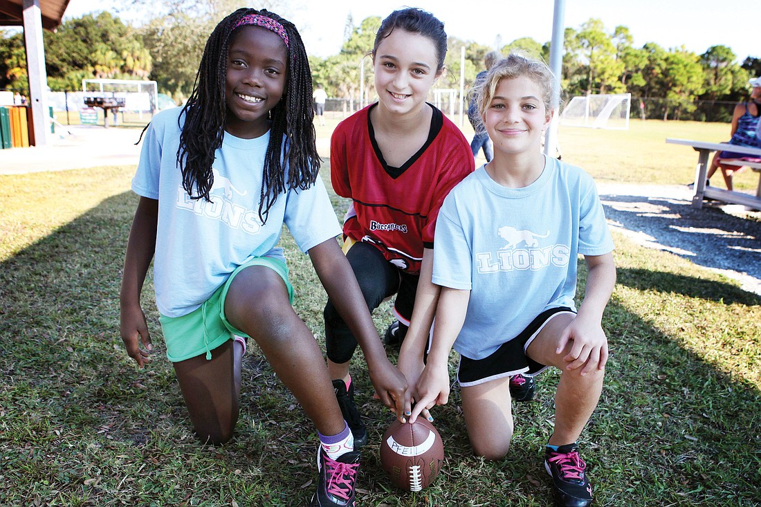 Bailey Saslow, 9, Chloe Delisle, 11, and Bianca Gruber, 9 1/2, pose together Saturday, Nov. 3, at Glebe Park. They are the only girls playing this season in the NFL Flag Football program that is offered through Suncoast Sports Club at Glebe Park.