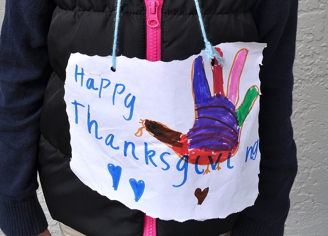 Kristina Spilkova, 6, wore a handmade "Happy Thanksgiving" sign around her neck Tuesday, Nov. 20, during school at Out-of-Door Academy.