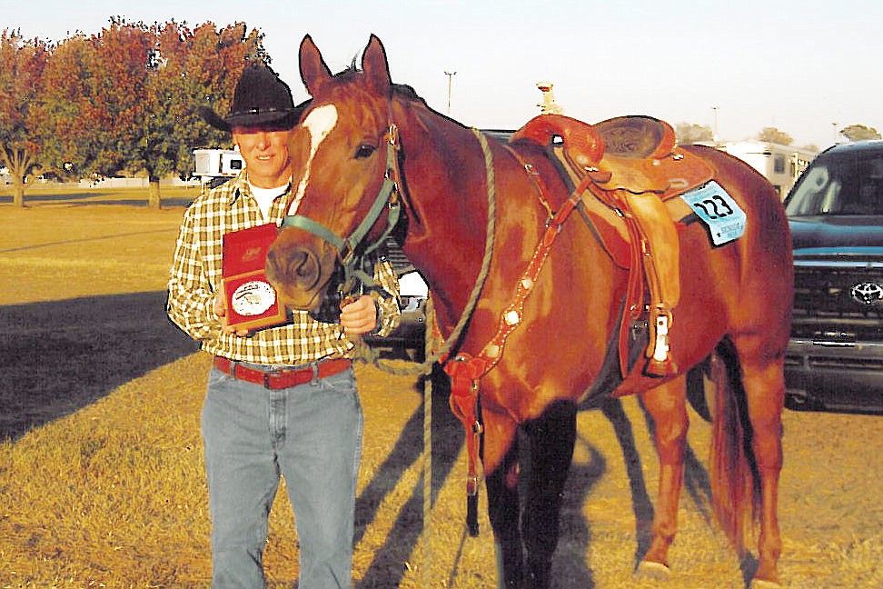 Kurt Dever shows off his championship belt buckle next to his horse, Dallas, who is officially registered as HereÃ¢â‚¬â„¢s Mud in Your Eye. Courtesy photo.