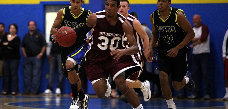 Riverviewâ€™s Austin Walker, No. 30, runs down the court with the ball.