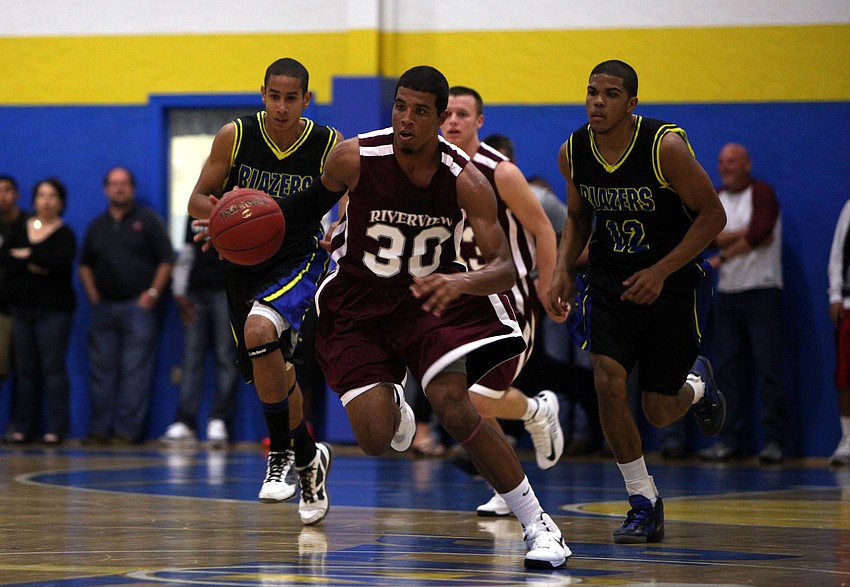 Riverviewâ€™s Austin Walker, No. 30, runs down the court with the ball.