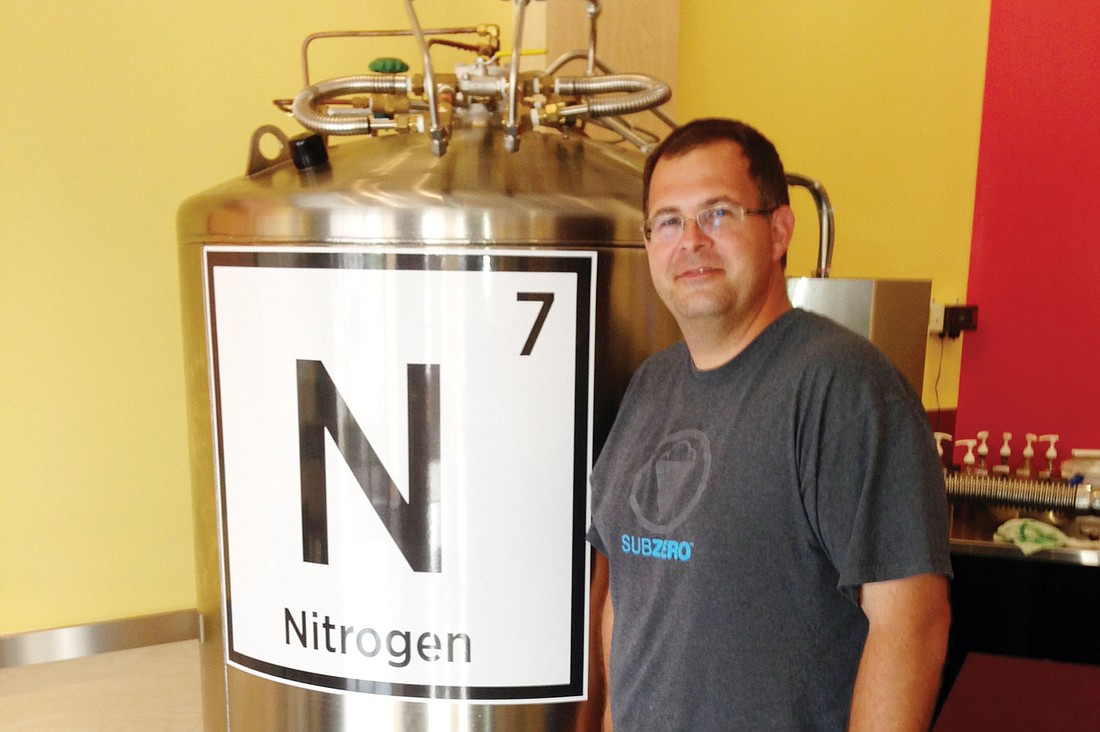 One of the owners of Sub Zero Ice Cream and Yogurt, Brad Lord, stands by a tank of 1,000 liters of liquid nitrogen.