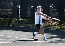 Dario Fallas goes for a backhand shot Tuesday, Nov. 27, during the Longboat Key Senior Clay Courts tournament at the Longboat Key Public Tennis Center.