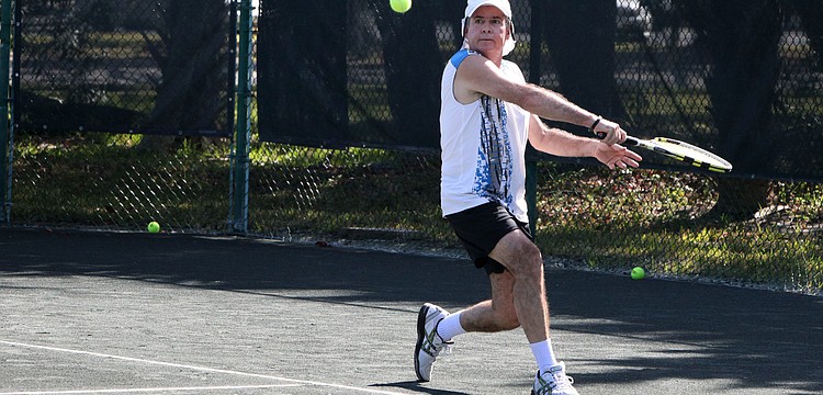 Dario Fallas goes for a backhand shot Tuesday, Nov. 27, during the Longboat Key Senior Clay Courts tournament at the Longboat Key Public Tennis Center.