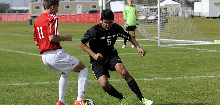 Braden River Highâ€™s Juan Morales looks to regain possession during the Pirates game vs. Clearwater in the Nike Thanksgiving High School Soccer Tournament Nov. 20.