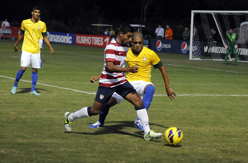 U.S. forward Junior Flores pushes the ball up the field against Brazil Nov. 28.