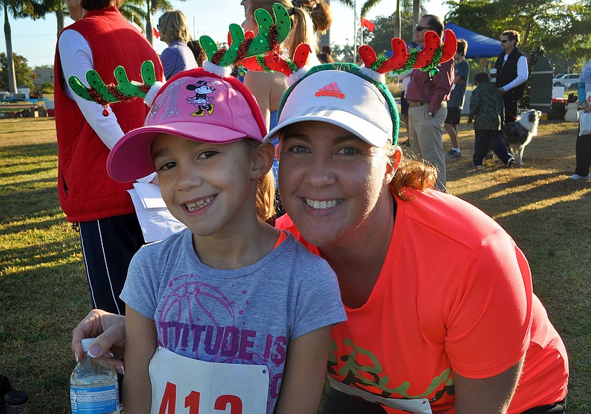 Erika Gonsalves, 7, and her mom, Lisa, wore colorful reindeer antler headbands for the 2nd Annual Achieva Reindeer Trot Saturday, Dec. 1, at Payne Park.