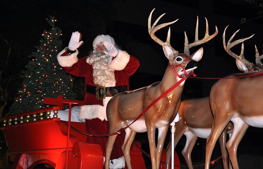 Santa waves to the crowd from his sleigh Saturday, Dec. 1, during the Downtown Sarasota Holiday Parade.