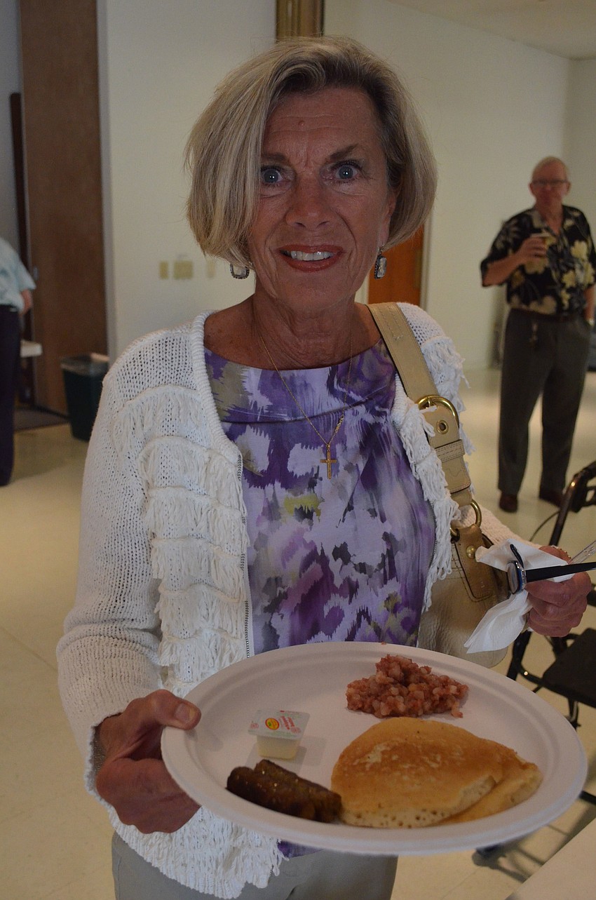 Arlene Luisa gets pancakes after the 10:30 a.m. church service at St. Michael the Archangel Catholic Church.