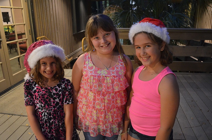 Chloe Johnson stands with her sister Grace and friend Emily Freed [middle].