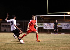 Bookerâ€™s Solomon LaBone Etienne, No. 27, tries to make his way down the field to score as Cardinal Mooneyâ€™s Patrick Lustro, No. 21, attempts to stop him.