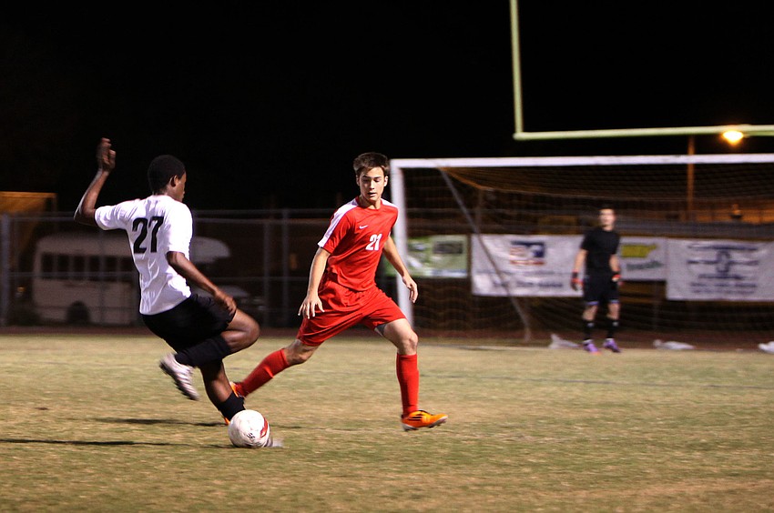 Bookerâ€™s Solomon LaBone Etienne, No. 27, tries to make his way down the field to score as Cardinal Mooneyâ€™s Patrick Lustro, No. 21, attempts to stop him.