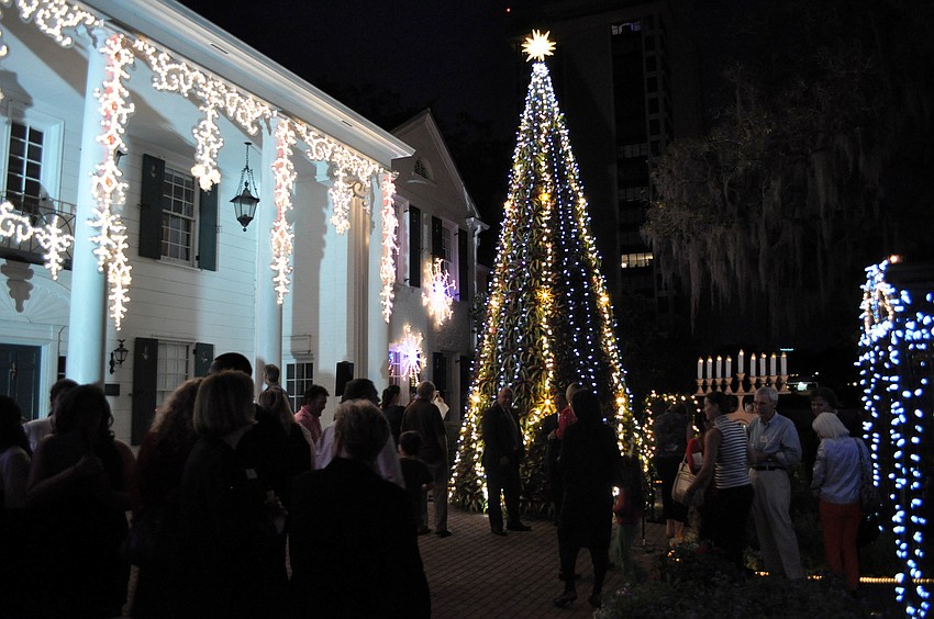 The crowd enjoys taking in the lights on the tree and around the courtyard Tuesday, Dec. 4, at the annual lighting of the bromeliad tree at Marie Selby Botanical Gardens.