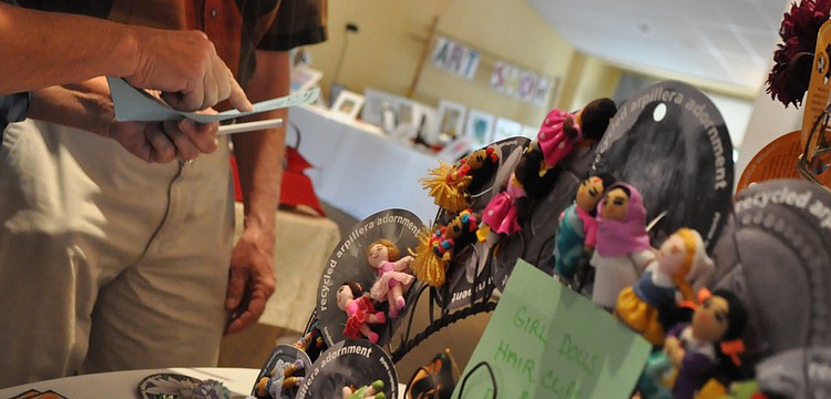 Diane Roytz and Rev. Bob Thacker look over fair trade items.