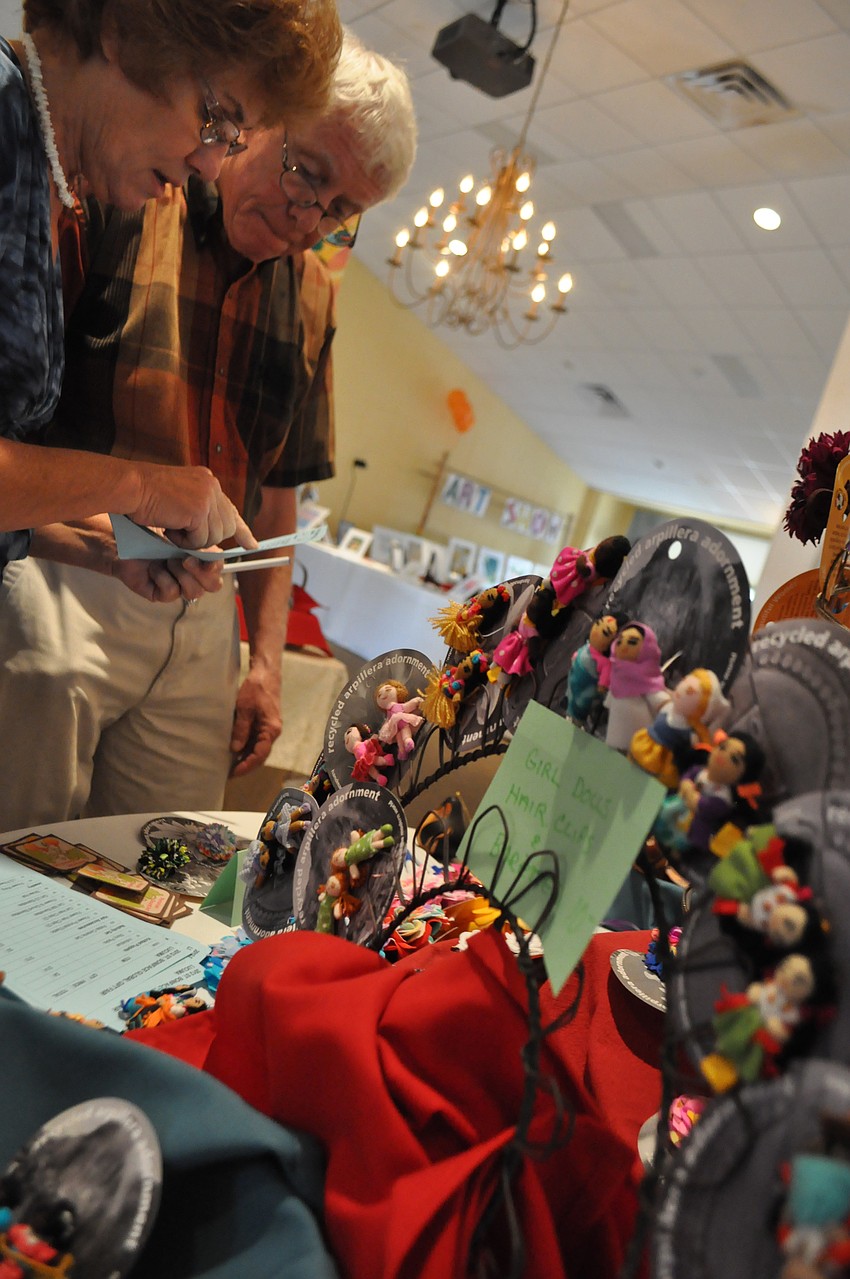 Diane Roytz and Rev. Bob Thacker look over fair trade items.