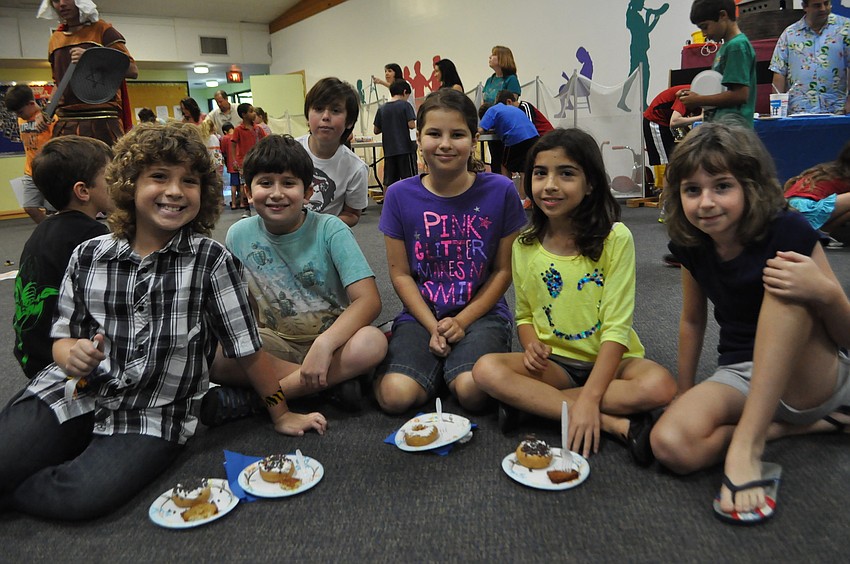 Charlie Timmons, Russell Kramer, Brianna Baldinger, Catarina Cappelli, and Katie Alcock eat Hanukah treats.