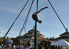 Performer, Egypt, hangs upside down as part of her routine.