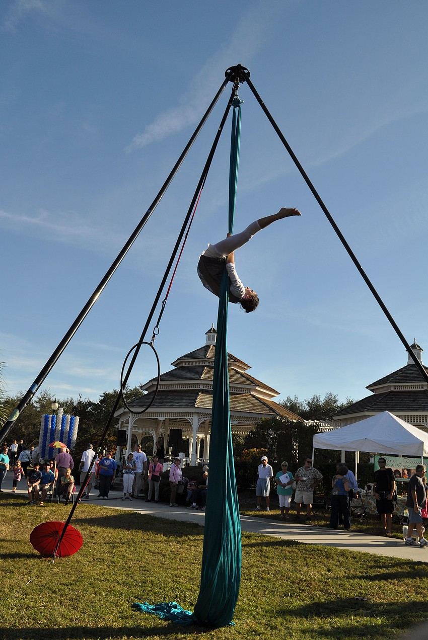 Performer, Egypt, hangs upside down as part of her routine.