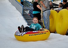 Evan Fonk sleds down a snow hill on an iner tube.