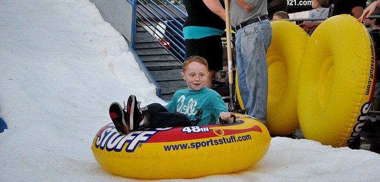 Evan Fonk sleds down a snow hill on an iner tube.