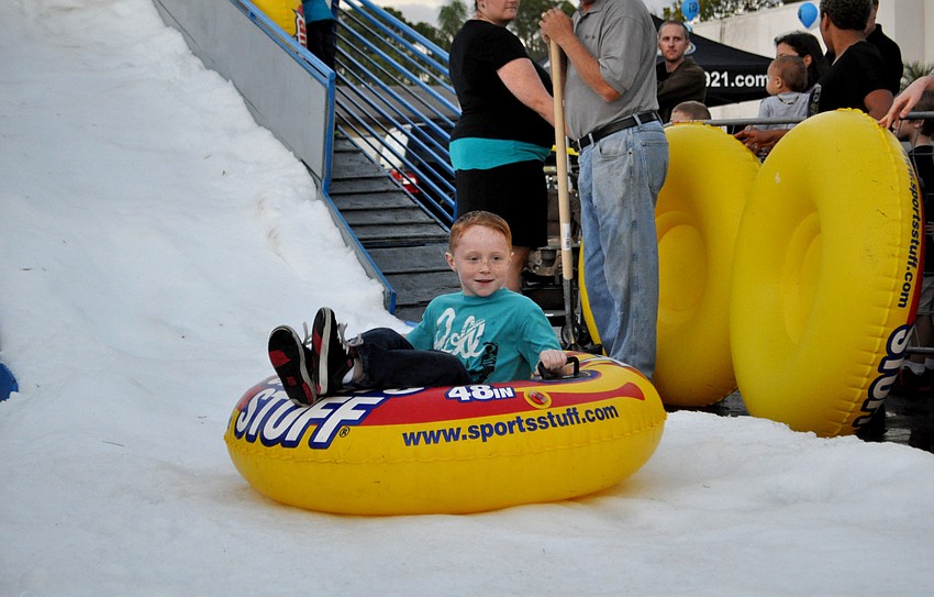 Evan Fonk sleds down a snow hill on an iner tube.