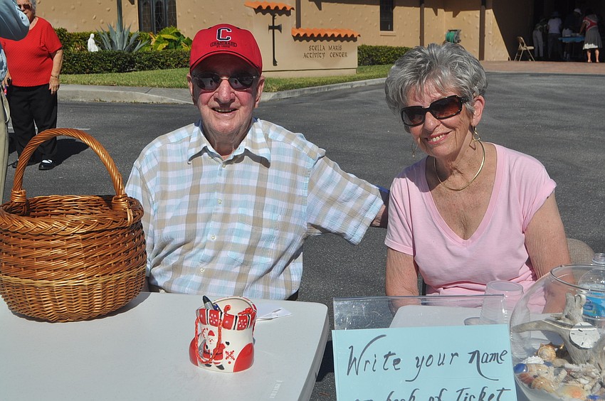 Jane and Al Bagot greet parishioners and take tickets.