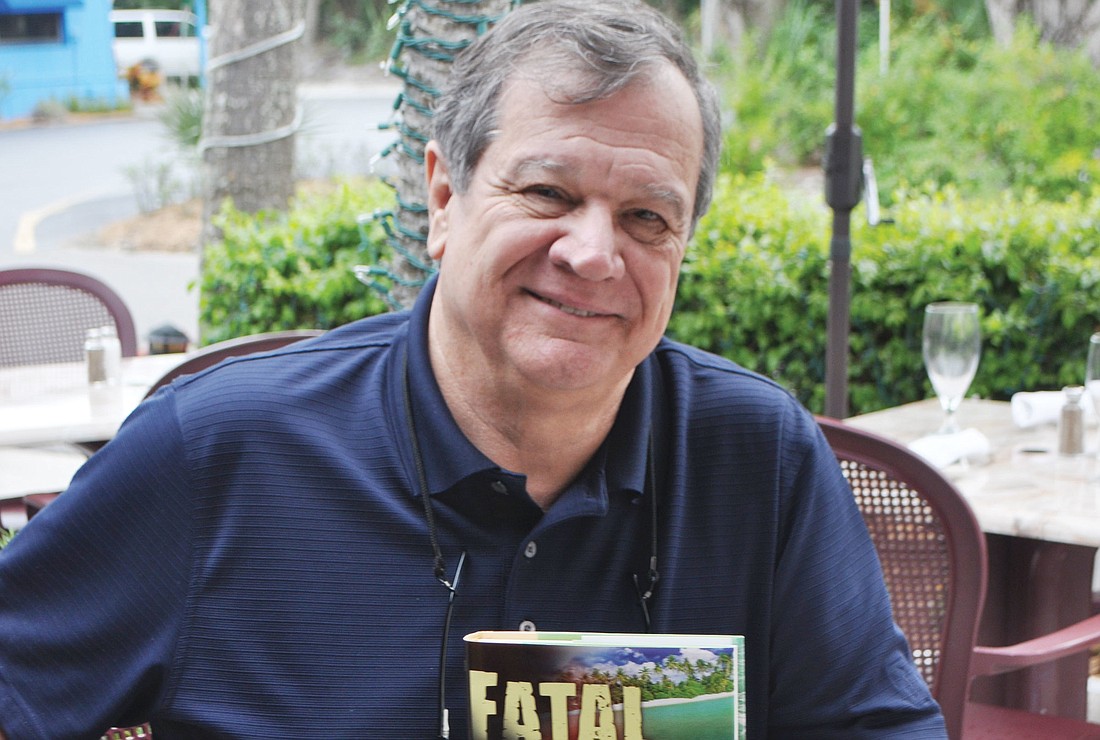 H. Terrell "Terry" Griffin holds a copy of his newest novel, "Fatal Decree," published by the Longboat Key-based Oceanview Publishing.