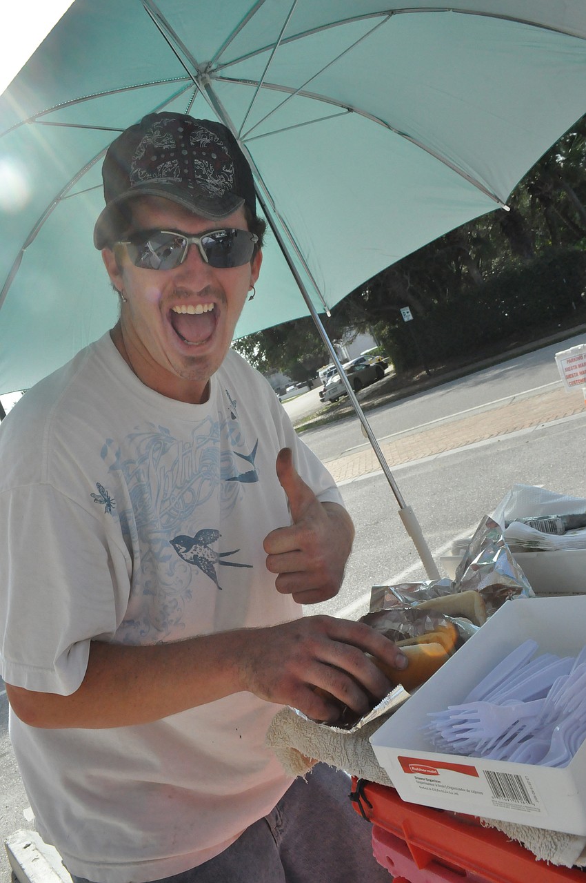 Tyler Tormey gets ready to eat some hotdogs at the 40 year celebration of Siesta Key Hardware Store.
