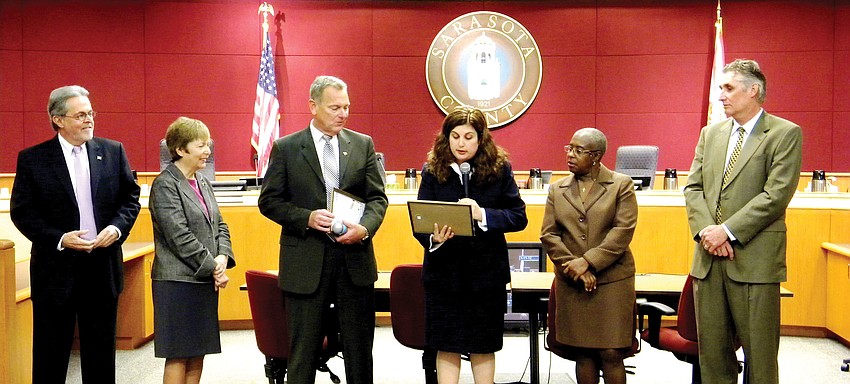 Sarasota County Commissioners Joe Barbetta, Nora Patterson, Christine Robinson, Carolyn Mason and Jon Thaxton surprised Interim County Administrator Terry Lewis [third from left] with special recognition for his service on Jan. 11.