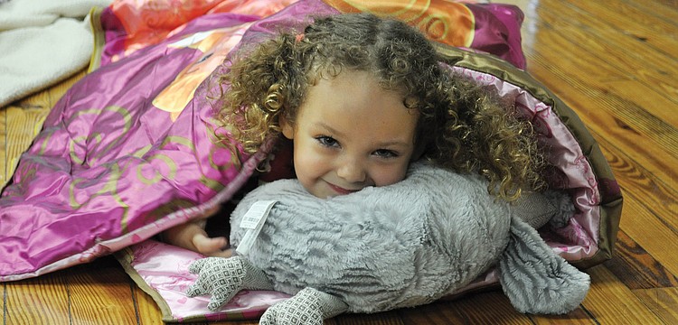 Kirin Singer snuggles up for story time at Out-of-Door Academy Jan. 27. ODA teachers led interactive songs and skits to promote the importance of reading.