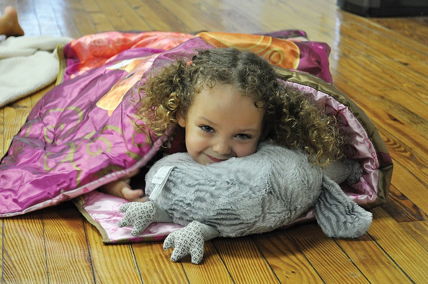 Kirin Singer snuggles up for story time at Out-of-Door Academy Jan. 27. ODA teachers led interactive songs and skits to promote the importance of reading.