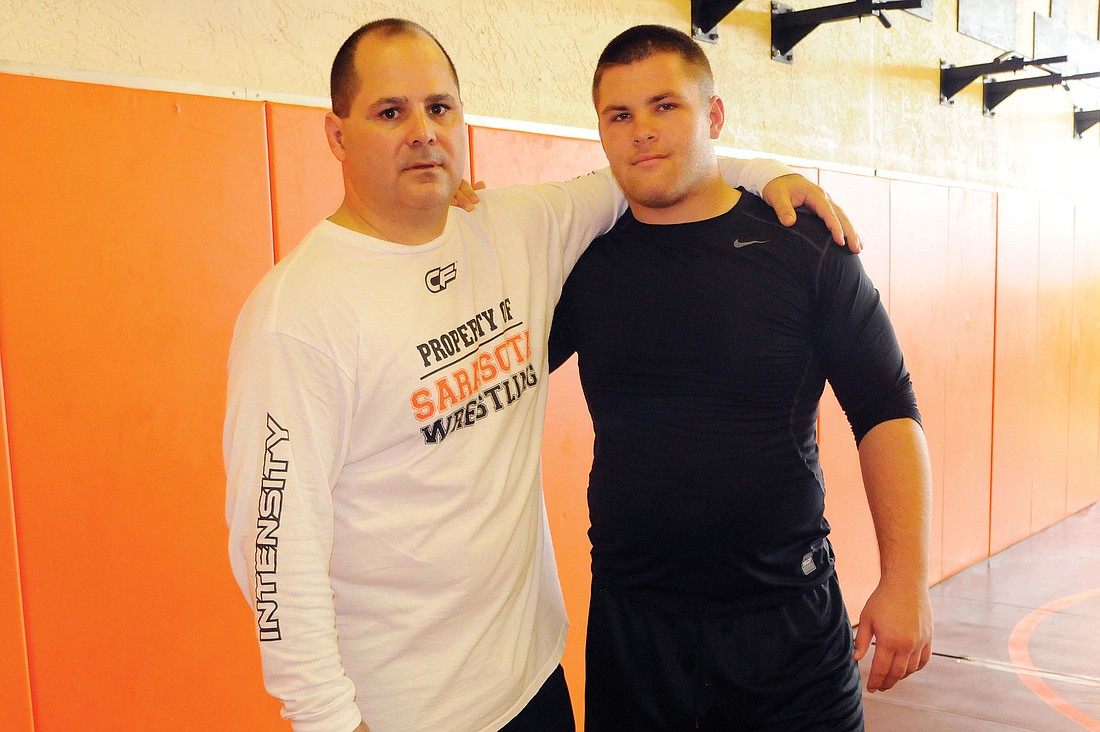 Sarasota High first-year head wrestling coach Cezar Sharbono and junior heavyweight Tobias Baker are adjusting to their new roles with the Sailors this season.