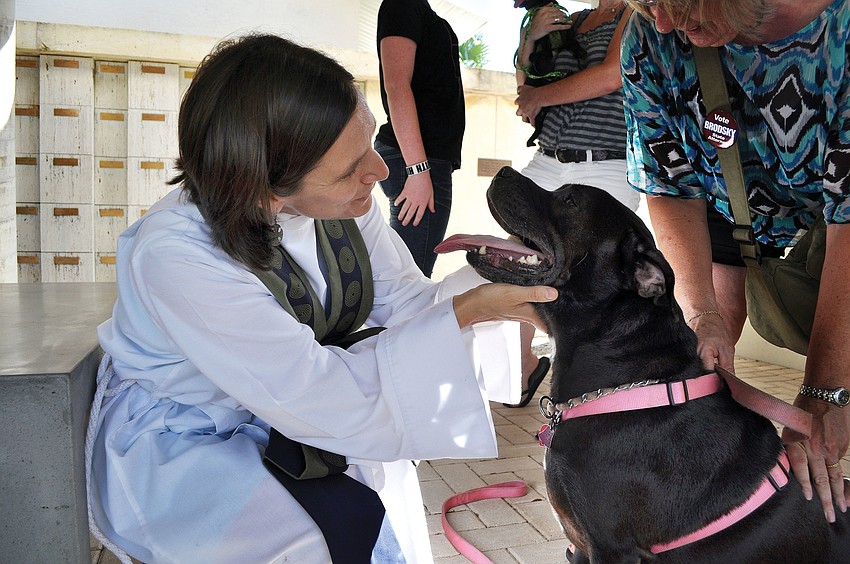 Associate Rector and Taylor blesses Baby, 6, during the animal blessing Sunday, Sept. 30, at St. Boniface Episcopal Church.