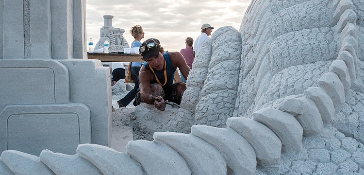 Delayne Corbett works on the first-place sculpture, â€œFossil Fuel,â€ at the Siesta Key Crystal Classic Master Sand Sculpting Competition, which took place on Siesta Key Beach, Nov. 8 through, Nov. 12.