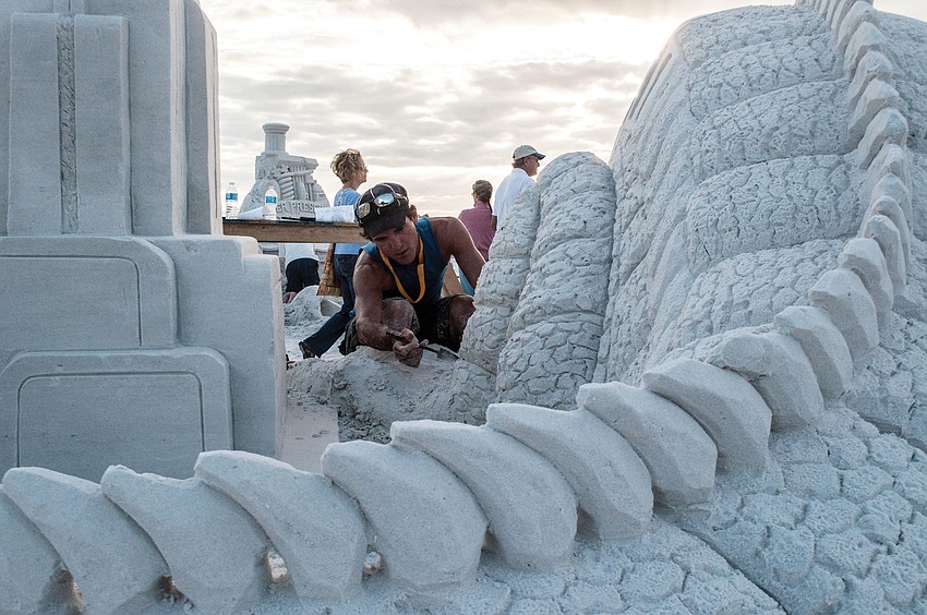 Delayne Corbett works on the first-place sculpture, â€œFossil Fuel,â€ at the Siesta Key Crystal Classic Master Sand Sculpting Competition, which took place on Siesta Key Beach, Nov. 8 through, Nov. 12.