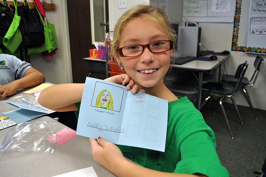 Audra Mullins shows off her passport.