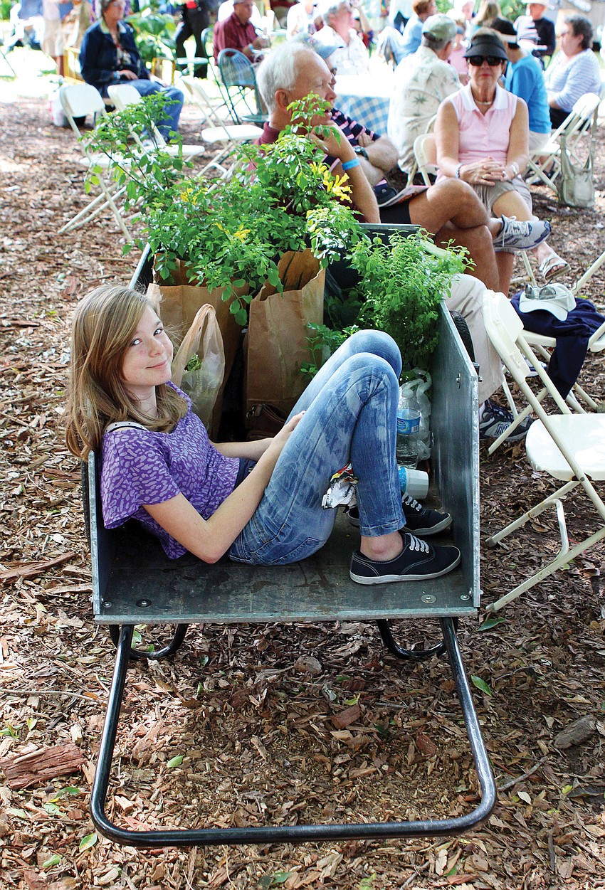 Allie Purcell, 13, loved riding in a wagon full of plants and flowers at the Plant and Garden Festival at the Marie Selby Botanical Gardens.