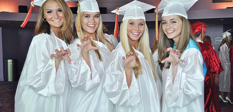 Briana Smith, Layni Chamberlain, Angela
Mich and Claire Whitacre show off their Cougar spirit during Cardinal Mooneyâ€™s graduation ceremony at the Van Wezel.