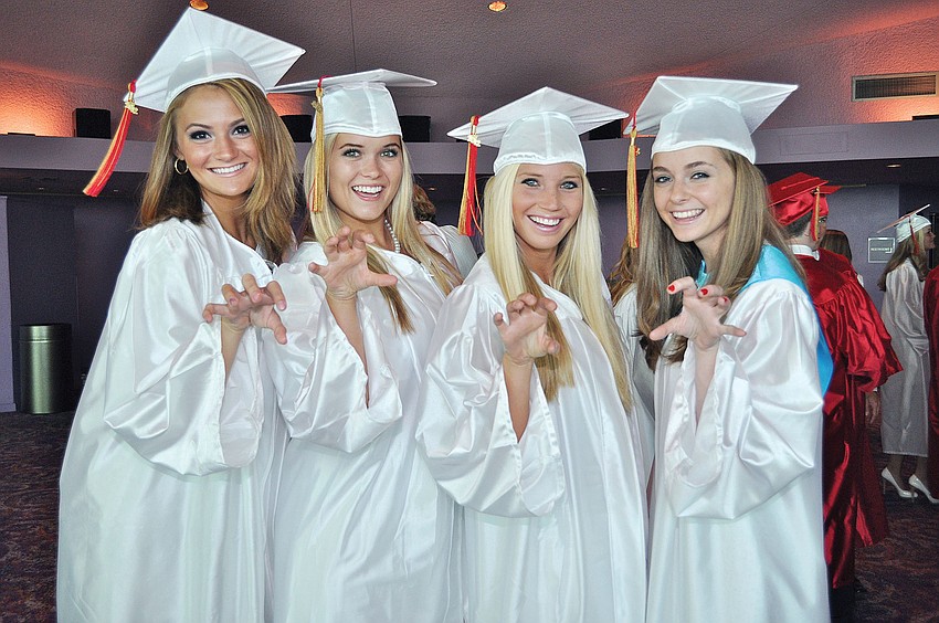 Briana Smith, Layni Chamberlain, Angela
Mich and Claire Whitacre show off their Cougar spirit during Cardinal Mooneyâ€™s graduation ceremony at the Van Wezel.