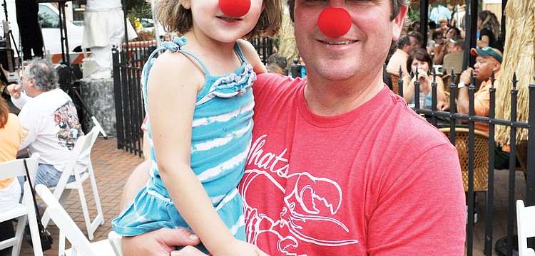 Todd Tedder and his daughter, Sophia, wore clown noses to the downtown block party that was held at Mattison's City Grille to watch local circus performer Nik Wallenda's daring tightrope walk over Niagara Falls.